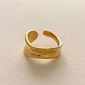 Macro view of gold irregular wavy ring with modern minimalist molten metal texture - Gold