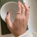 Detailed view of an S925 sterling silver hollow heart ring worn on a finger - Adjustable Open / Silver
