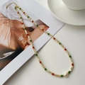 Detailed close-up of handmade S925 silver beaded necklace with freshwater pearl and shells - 925 Silver / Gold