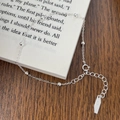 Detail of 925 sterling silver beaded bracelet with adjustable chain on a wooden desk - Bead Chain / Silver