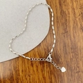 Macro view of S925 sterling silver olive bead bracelet with lobster clasp and heart charm - 925 Silver / Silver