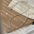 Detail of S925 silver beaded necklace with blue aquamarine gems and bow pendant - Bow Aquamarine Beaded Necklace (SN3333) / Silver