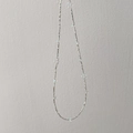 Macro detail of S925 silver beaded necklace with rainbow iridescent bubble beads - Silver