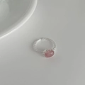 Detail view of the braided chain texture and oval pink crystal on the silver open ring - Adjustable Open / Strawberry Quartz