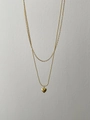 Detail einer doppellagigen Goldkette mit Herzanhänger sowie Kugel- und Ankerkette - 925er Silber / Gold