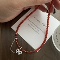Macro shot of S925 sterling silver bow pendant with red agate beads and micro-set diamonds - Red Beaded Bowknot Pendant Necklace (SN3410)