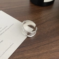 Macro view of multi-layer S925 sterling silver streamlined ring on elegant background - Narrow Version