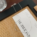 Detail of S925 sterling silver wavy necklace with sparkling cubic zirconia on a white card - 925 Silver / Silver