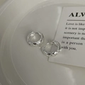 Macro shot of silver S925 sterling silver hoop earrings with a rhombic pattern design - 925 Silver / Silver