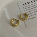Close-up of golden checkered pattern earrings on a minimalist white ceramic tray - 925 Silver / Gold