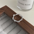 Detailed shot of an adjustable S925 silver star ring on a dark wood jewelry box edge - Adjustable Open / Silver