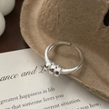Macro detail of S925 sterling silver ring featuring triple ring decor on a gift card - Adjustable Open / Silver