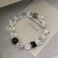 Macro view of S925 silver beaded bracelet featuring green avocado and brown crystals - 925 Silver / White Crystal