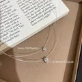 Detail view of 5mm and 6.5mm cz solitaire pendants on invisible fishing line necklace - 5mm Spec / White Gold