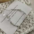 Detail of S925 sterling silver beaded bracelet featuring a heart charm and adjustable chain - 925 Silver / Silver