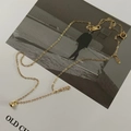 Macro detail of a minimalist gold bead pendant on a delicate silver cable chain necklace - 925 Silver / Gold