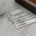 Detailed view of silver twist hoop earrings with polished metal bead on vintage card - 925 Silver / Silver