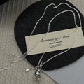 Detail of S925 silver necklace with minimalist clear crystal sphere on black felt background - 925 Silver / White Crystal