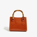 Glossy orange PVC handbag featuring a vintage bamboo handle and elegant golden ring buckles - 200*100*160mm / Tan