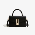 Elegant matte black leather mini crossbody bag with a distinctive golden metal buckle - Black
