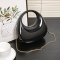 Glossy black acrylic half-moon handbag with hollow round handle and golden chain strap - Black