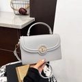 Minimalist light gray litchi grain leather handbag with gold round twist lock - Gray