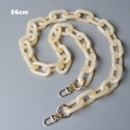 Detail view of 86cm cream acrylic chain strap with marble texture and gold lobster clasps - Beige Marble (86cm)