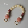 Détail d'une chaîne de sac 31cm en perles de résine colorées avec fermoirs dorés - 31cm / Rose