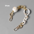 Detail of 31cm gold metal and white marble resin bag chain with lobster clasps - 31cm / Beige