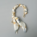Close-up of gold metal chain intertwined with floral silk scarf for handbags - Standard Size / Blue Base Yellow Fruit Green Leaf Print (4)