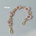 Detailed view of a 34cm pink acrylic resin and gold metal chain strap for handbags - Pink 34cm