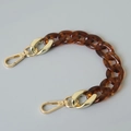 Detail of tortoise shell acrylic chain link with golden metal lobster clasps for bags - 28cm / Amber