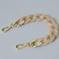 Detail of chunky apricot resin fishbone chain with premium golden metal spring clasps - 28cm / Apricot