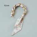 Close-up of 32cm luxury gold chain strap with printed silk scarf wrap for handbags - Red Lips Style