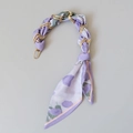 Detail of lavender floral silk scarf woven through gold metal chain handle strap - Purple Floral Style