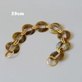 Detail view of a 39cm vintage brown resin acrylic chain with gold metal links and clasps - Oval Link - 39cm