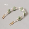 Détail d'une chaîne de sac 37cm perles vert clair et blanc avec fermoirs mousquetons dorés - Vert