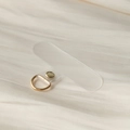 Close-up of frosted TPU phone lanyard tether tab with a premium gold metal D-ring buckle - Gold Frosted Translucent