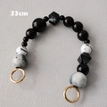 Detalle de cadena de bolso de 33cm en resina jaspeada con cierres dorados - Estilo de Patrón de Mármol Blanco y Negro
