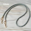 Detail showing 120cm grey woven crossbody phone strap with golden lobster clasps - Grey and Neon Yellow Geometric (Style 5)
