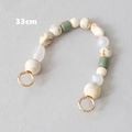 Kralen tasriem van 33cm met crème en marmeren harskralen en gouden metalen ringen - Saliegroen Marmer Stijl