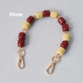 Detail view of 35cm beaded chain strap with red and yellow resin beads and gold lobster clasps - Red & Yellow Contrast (Style 5)