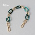Detail view of a 32cm bag handle with green resin links and golden lobster clasps - 32cm / Green