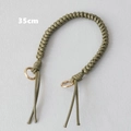 Detailed view of olive green 35cm braided wax rope handbag strap with gold metal rings - Green