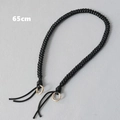 Detailed view of 65cm black braided rope handle with light gold metal rings for handbags - Black