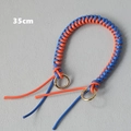 Close-up of a 35cm orange and blue braided rope handbag strap with gold metal rings - Blue & Orange