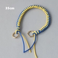 Detail of a 35cm blue and yellow woven handle chain with gold ring clasps - Blue and Yellow