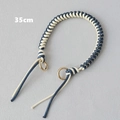 Detailed view of a 35cm blue and cream woven rope handle with gold circular metal clasps - Blue & White
