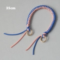 Detailed view of a 35cm blue and pink woven wax rope bag handle with gold metal rings - Blue & Pink