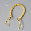 Close-up van 35cm gele gevlochten tasriem met gouden metalen klikringen - Geel